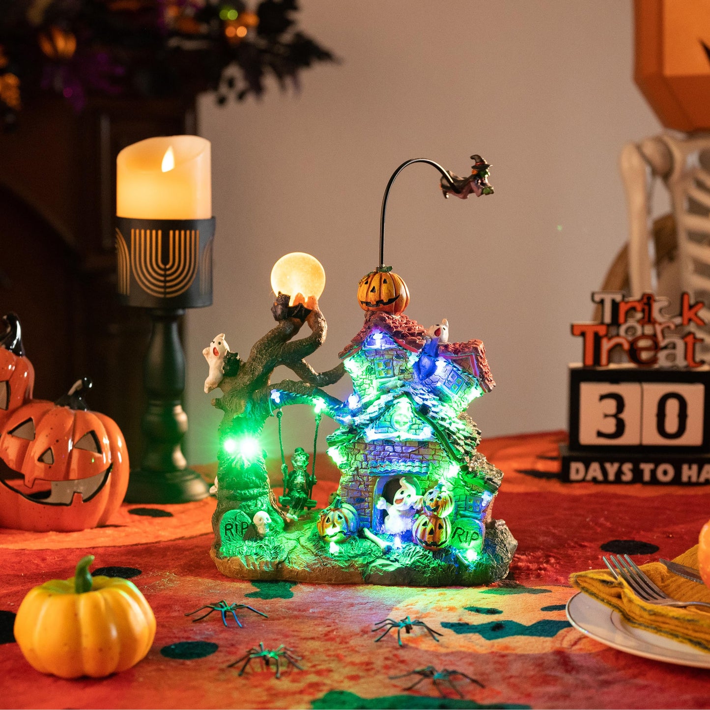 Valery Madelyn Halloween Decorations, Lighted Halloween Village Houses with Music and LED Lights, Resin Spooky Town Flying Witch and Haunted House for Home and Party Table Desk Mantel, 12 Inch